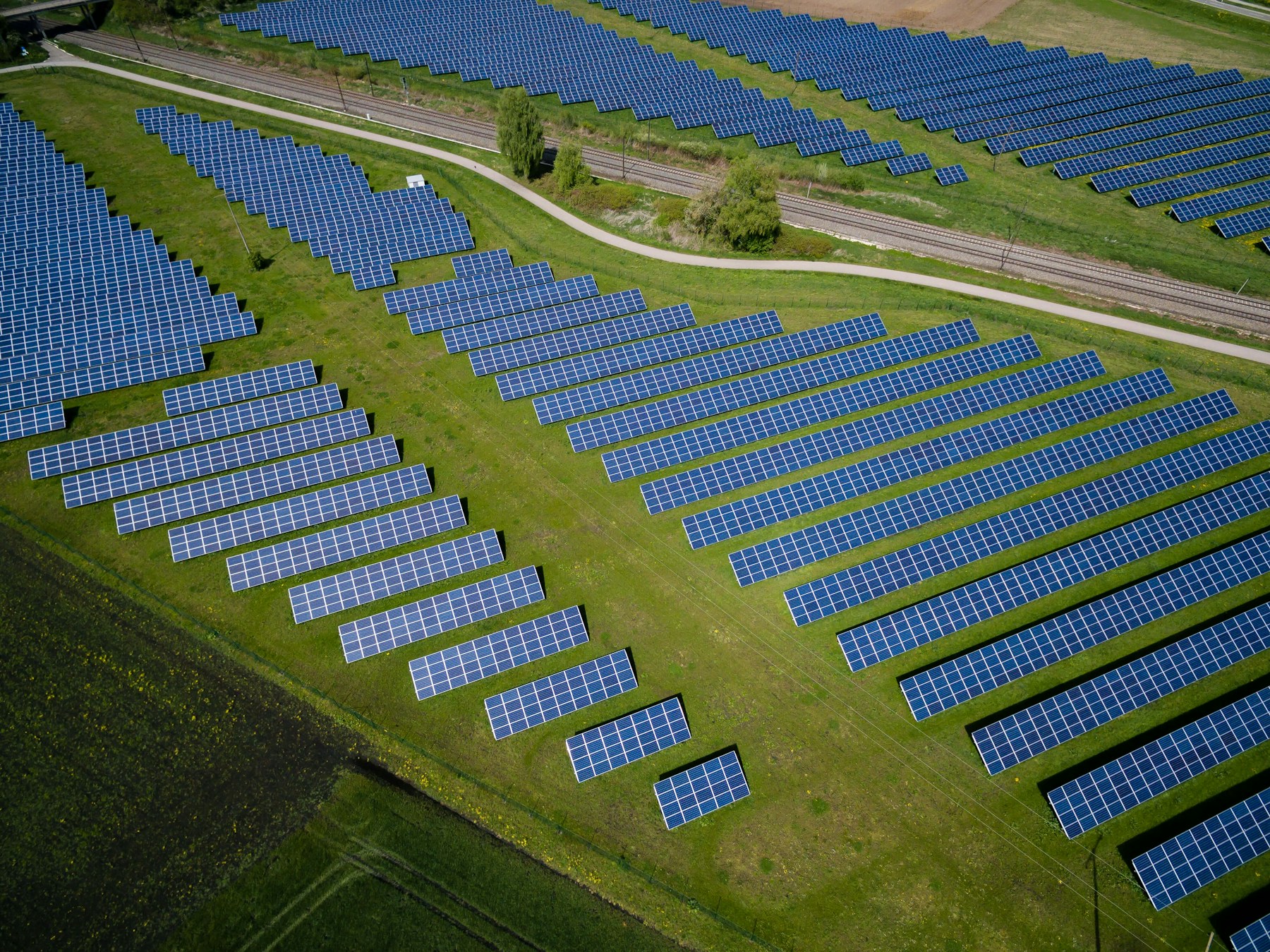 Aerial view of a large-scale solar panel farm supplying renewable electricity